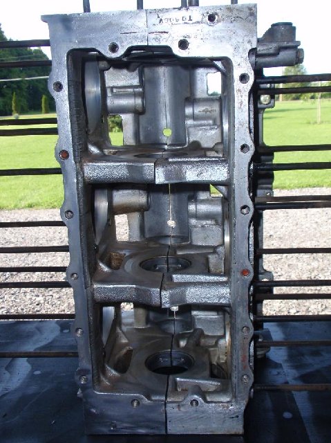 looking inside the block , we see that it is releived next to the cylinder openings for late cylinders / crankshaft clearances. basically , it is a very early casting on the outside (with the tapped boss for a 60 type choke ring support) with the late casting on the inside. the later (after 60-61) blocks did not have this area on the left side middle.